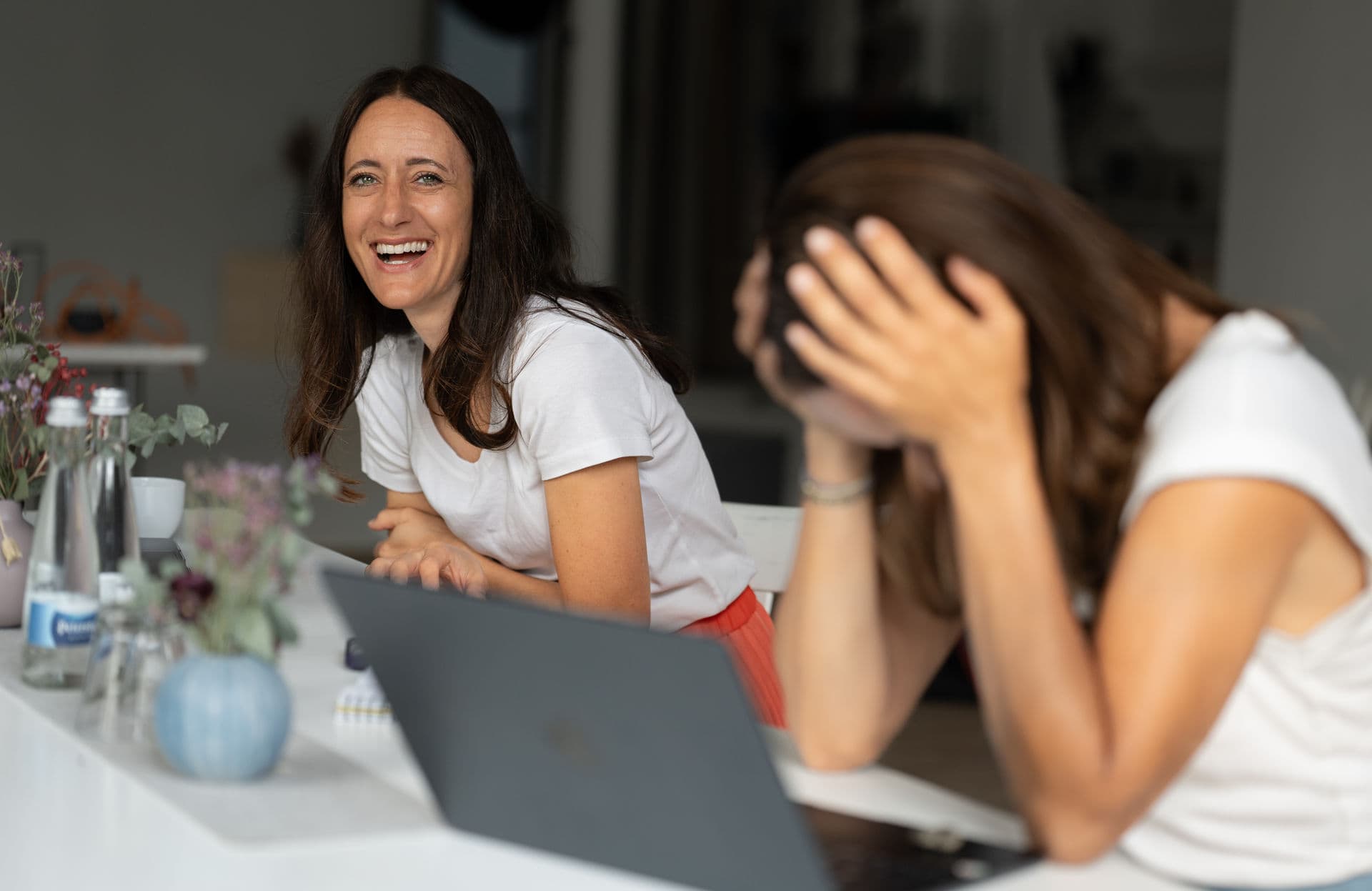 Dani and Tanja laughing at a table